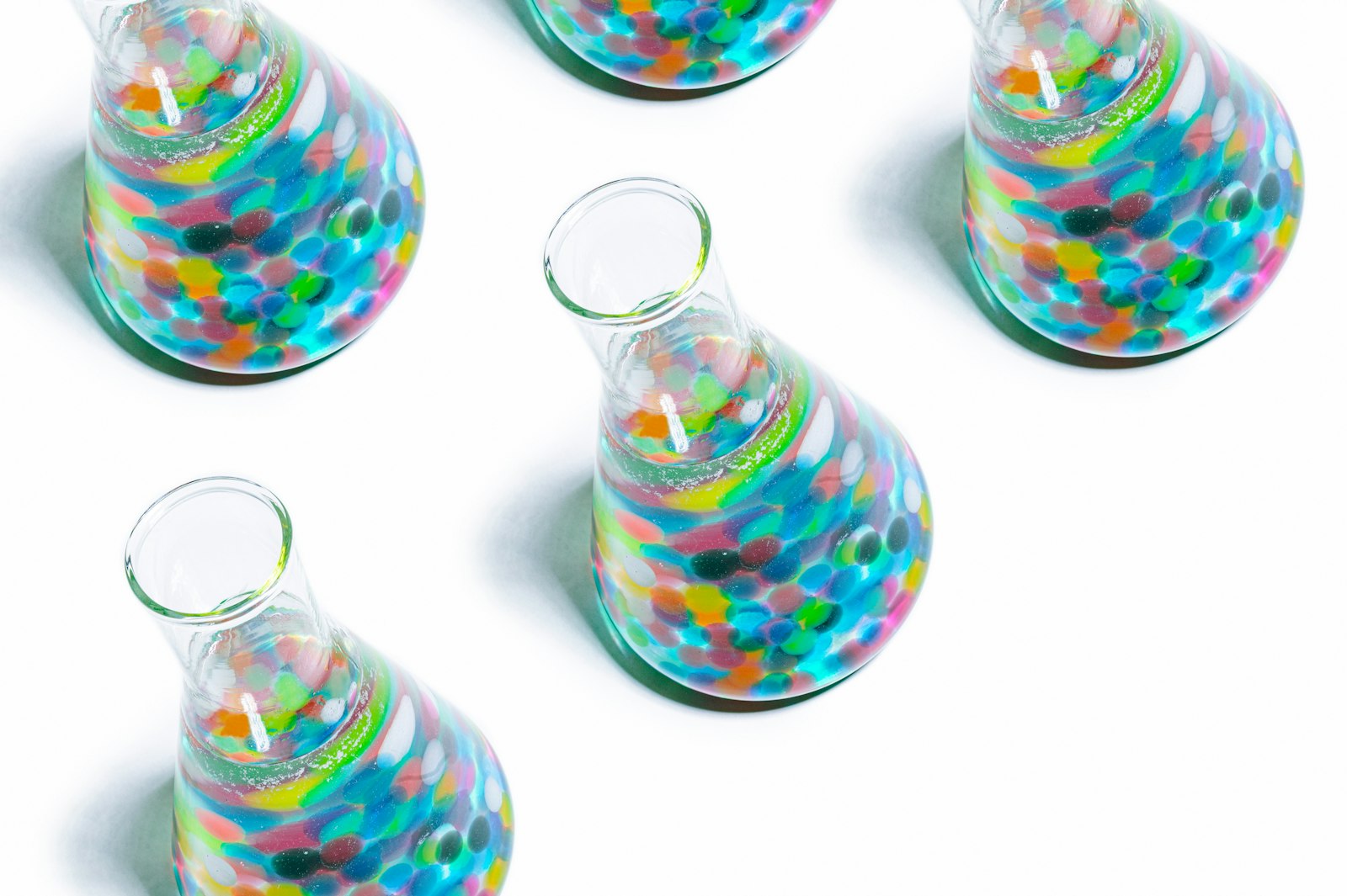 Erlenmeyer flasks containing coloured solutions